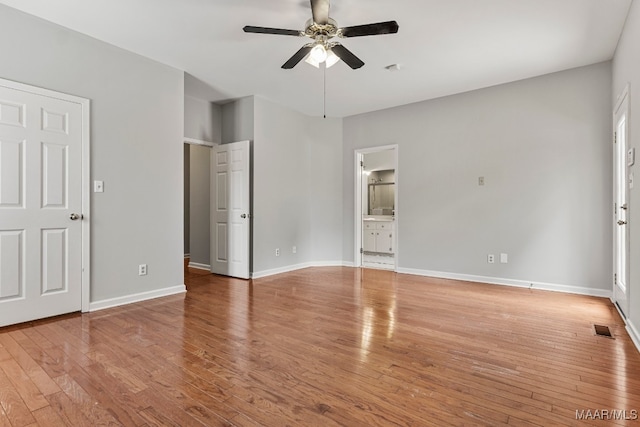 unfurnished bedroom with ensuite bath, ceiling fan, and light hardwood / wood-style floors