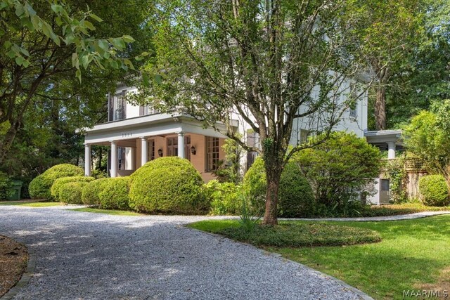 neoclassical home with a front yard