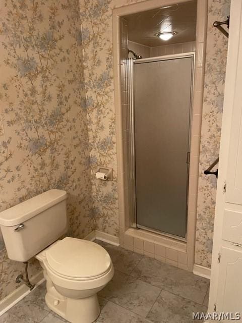 bathroom with toilet and an enclosed shower