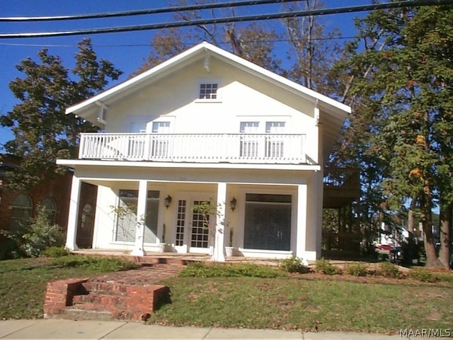 view of front of house featuring a porch, a balcony, and french doors