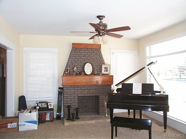 interior space with a brick fireplace and ceiling fan