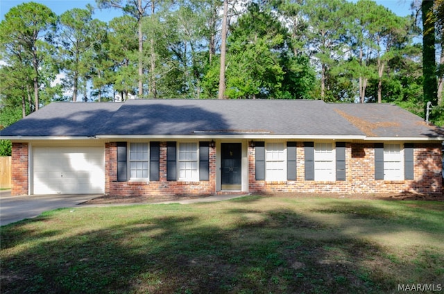 ranch-style house with a garage and a front lawn