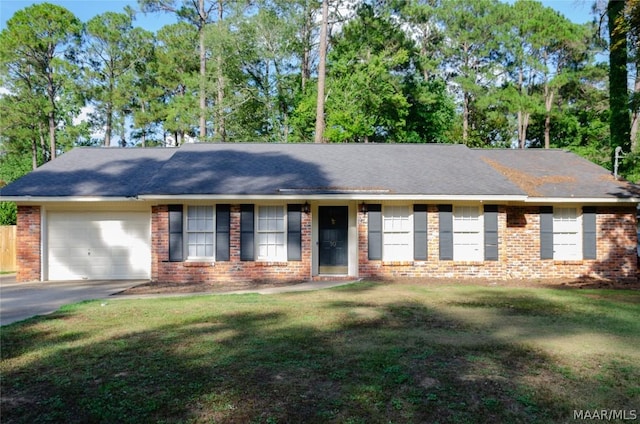 ranch-style house featuring brick siding, an attached garage, driveway, and a front yard