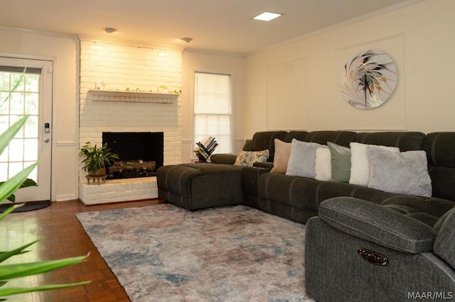 living room with a brick fireplace and ornamental molding