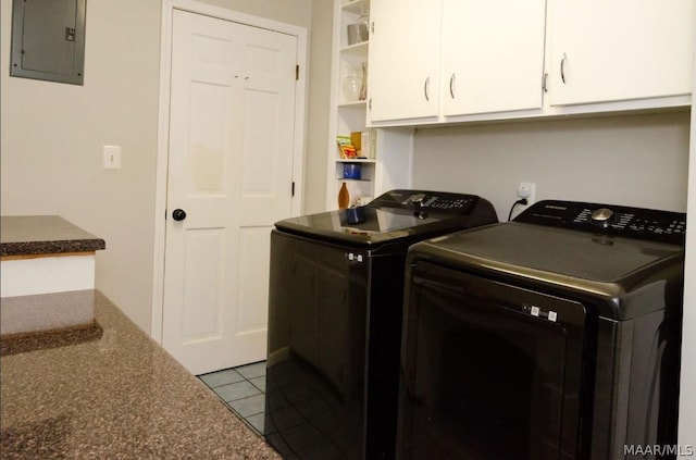 washroom with electric panel, tile patterned flooring, washer and dryer, and cabinet space