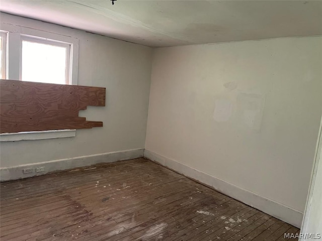 spare room featuring dark hardwood / wood-style floors