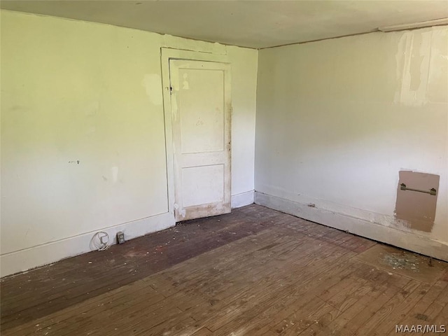 empty room featuring dark hardwood / wood-style flooring