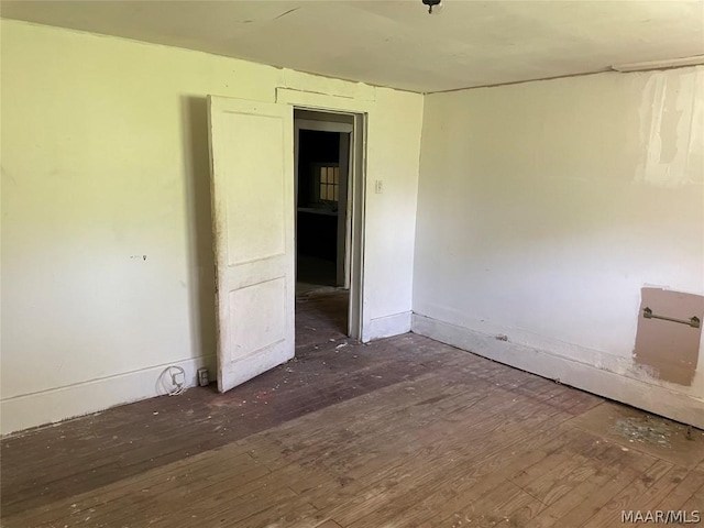 spare room with dark hardwood / wood-style flooring