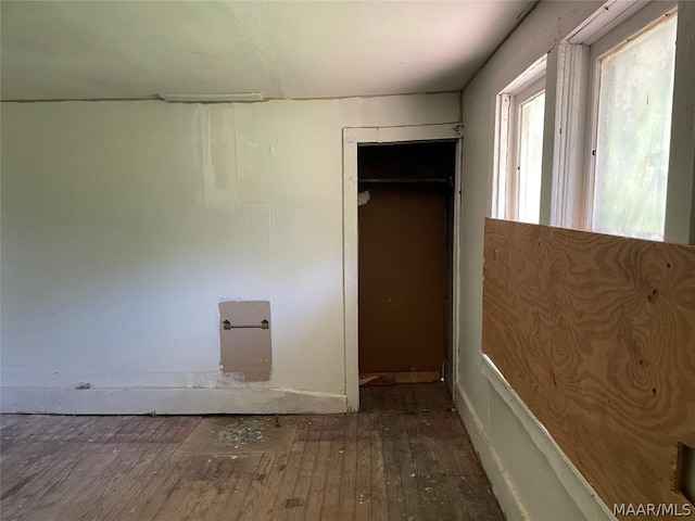 unfurnished bedroom featuring hardwood / wood-style flooring and a closet