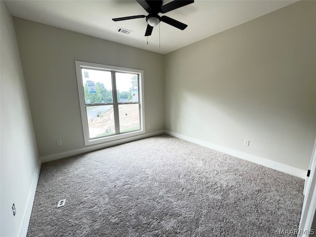 carpeted spare room featuring ceiling fan