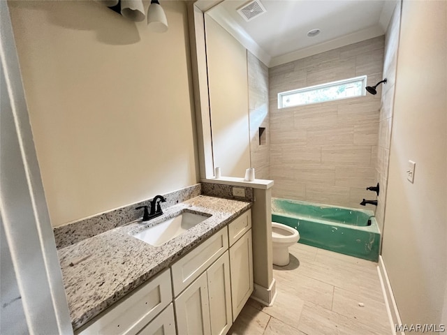 full bathroom featuring tiled shower / bath, vanity, and toilet