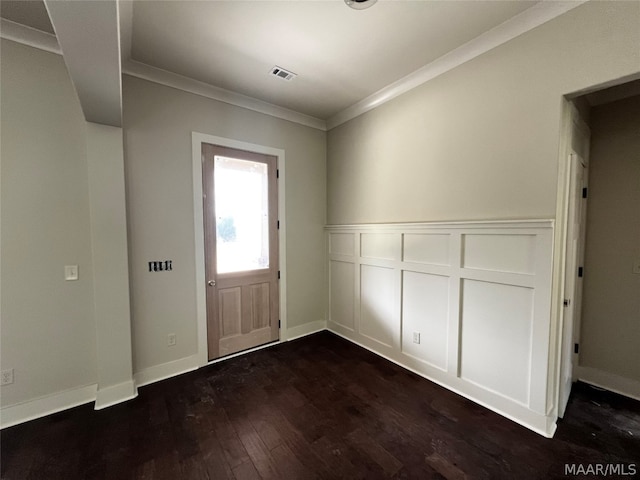 foyer featuring crown molding and dark hardwood / wood-style flooring