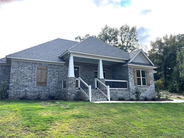 exterior space with a front yard and covered porch