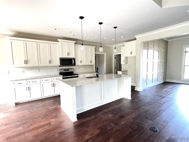 kitchen featuring white cabinets, pendant lighting, a center island with sink, dark wood-type flooring, and stainless steel appliances