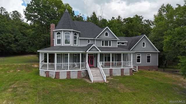 victorian home with a porch and a front yard