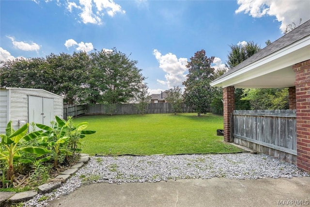 view of yard featuring a fenced backyard, a storage unit, and an outdoor structure