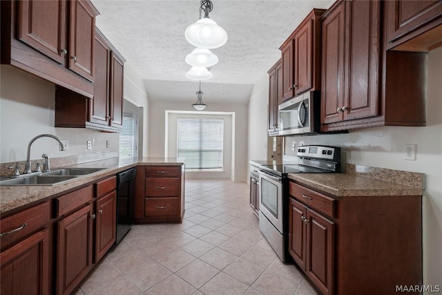 kitchen with light tile patterned floors, stainless steel appliances, hanging light fixtures, a sink, and a textured ceiling