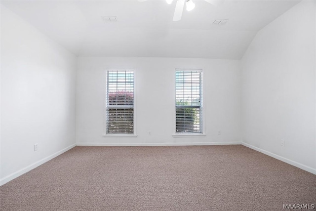 unfurnished room with lofted ceiling, carpet flooring, ceiling fan, and baseboards