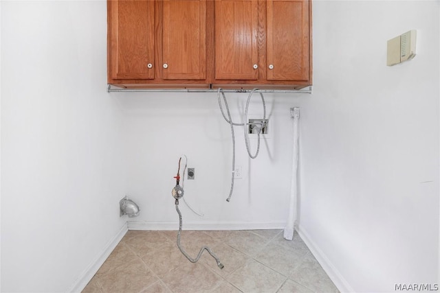 laundry area featuring cabinet space, baseboards, washer hookup, and electric dryer hookup