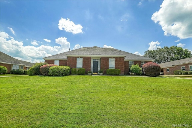 view of front facade featuring a front lawn and brick siding