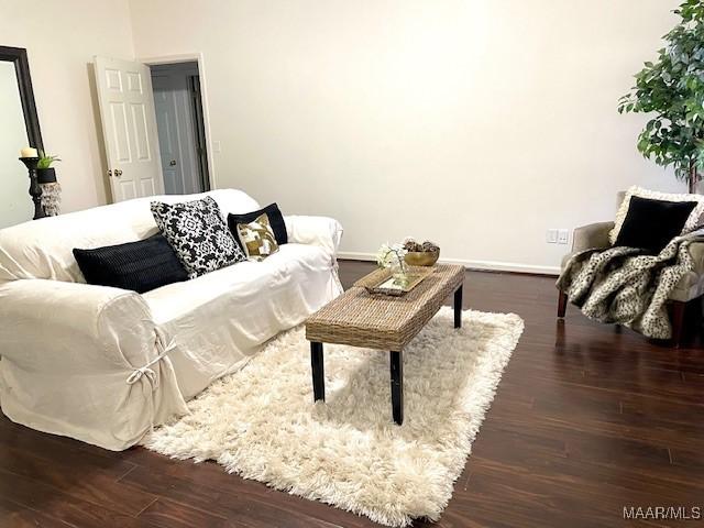 living room featuring dark wood-style flooring and baseboards