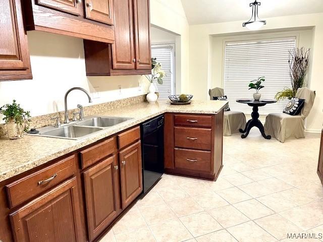 kitchen featuring black dishwasher, pendant lighting, light countertops, a sink, and a peninsula