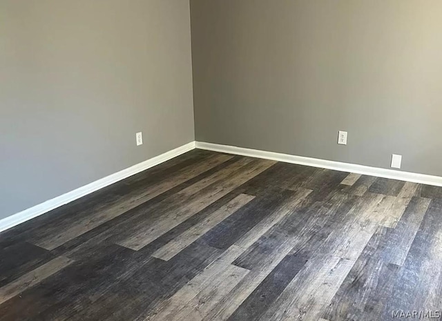 empty room featuring dark wood-type flooring