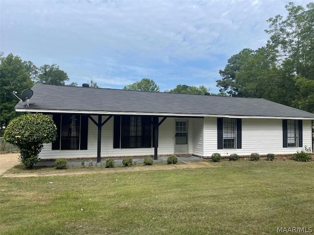 ranch-style house with a shingled roof, covered porch, and a front lawn