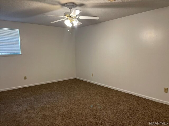 carpeted empty room featuring a textured ceiling and ceiling fan