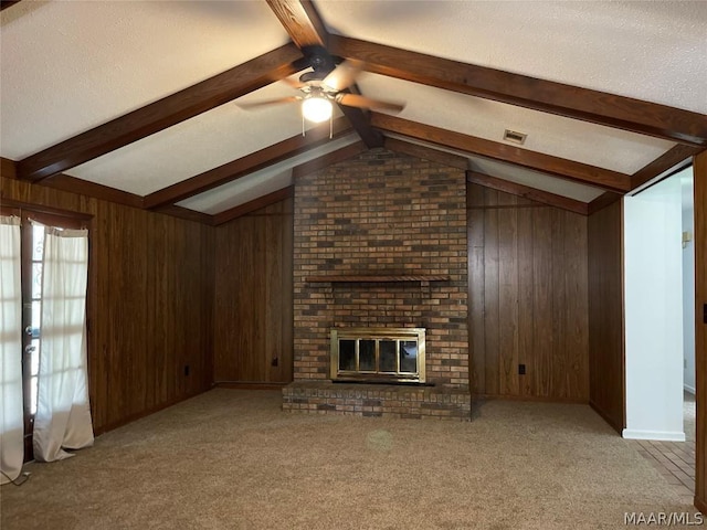 unfurnished living room featuring vaulted ceiling with beams, a brick fireplace, light colored carpet, and wooden walls