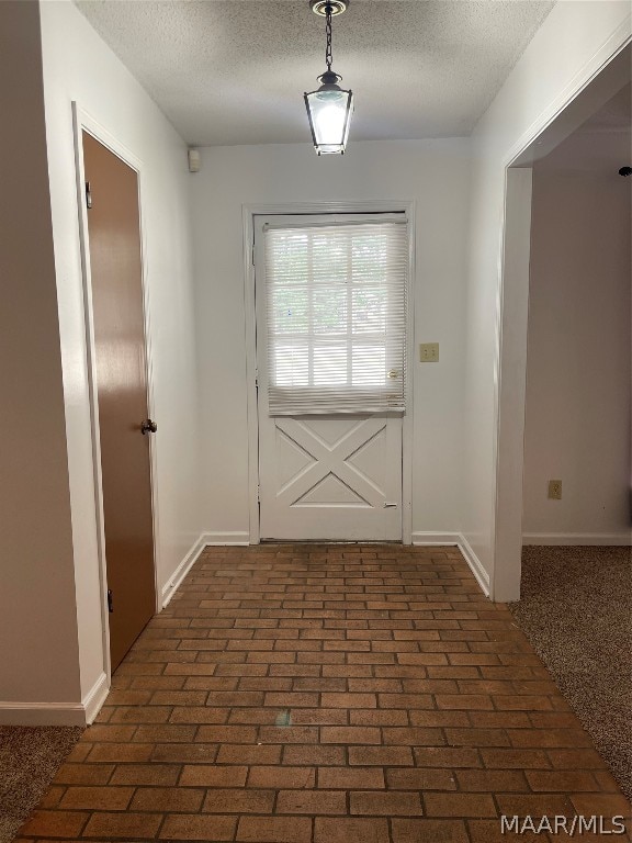 entryway featuring a textured ceiling