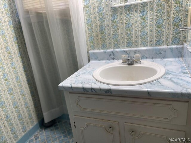 bathroom featuring tile patterned flooring and vanity