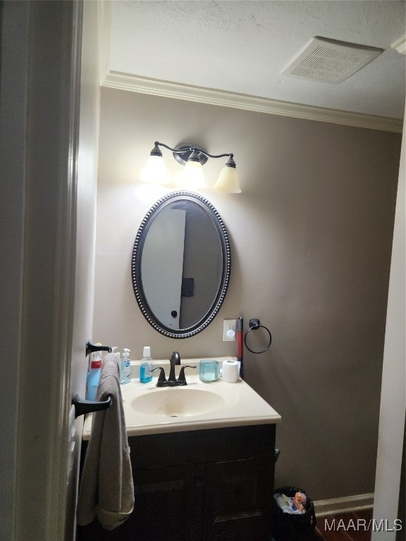 bathroom featuring vanity and ornamental molding