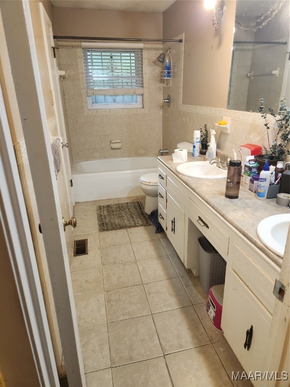 full bathroom with tile patterned flooring, vanity, toilet, and tiled shower / bath