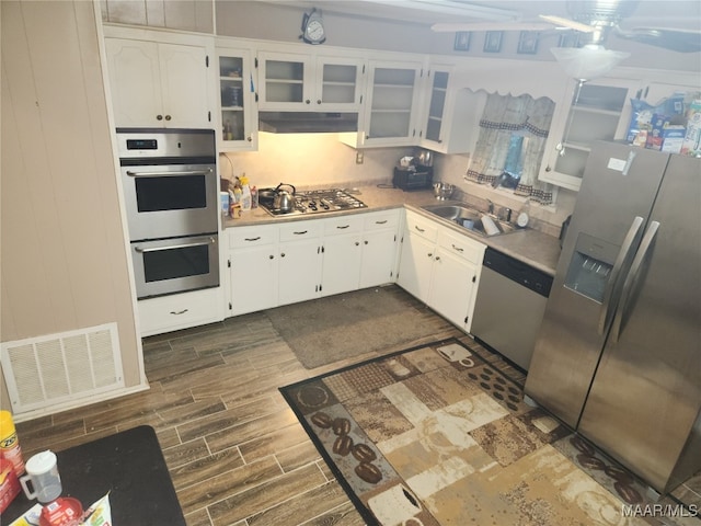 kitchen featuring white cabinetry, appliances with stainless steel finishes, and sink