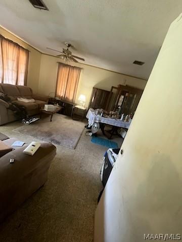 carpeted bedroom with visible vents and a ceiling fan