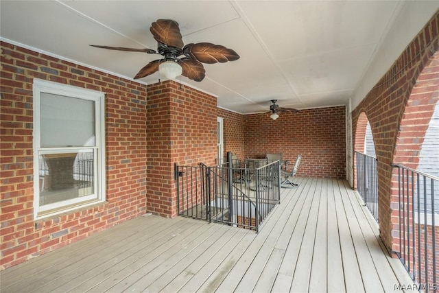 wooden terrace featuring a ceiling fan and outdoor dining area