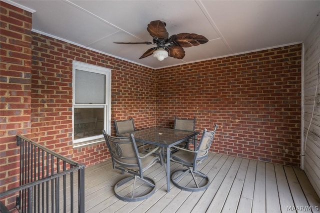 deck with outdoor dining area and a ceiling fan