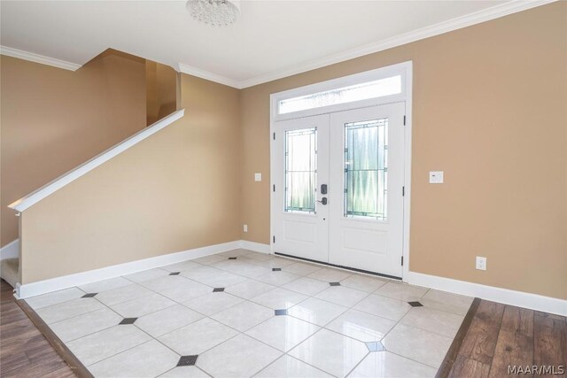 foyer entrance featuring ornamental molding, french doors, and light hardwood / wood-style floors