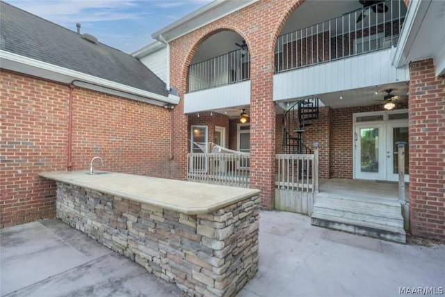 view of patio / terrace featuring a balcony and french doors