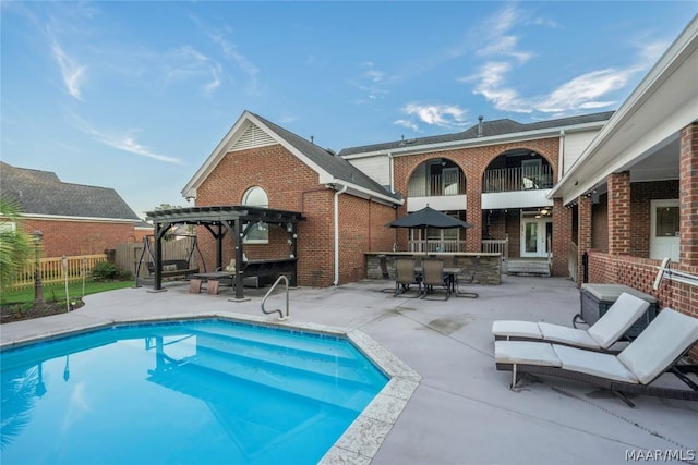 view of pool with a fenced in pool, fence, french doors, a patio area, and a pergola