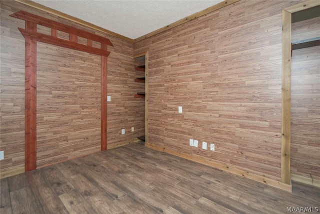 unfurnished room with wood finished floors