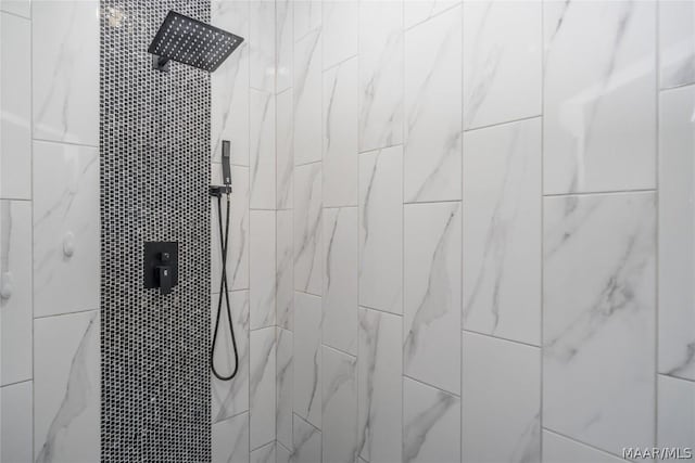 interior details featuring tiled shower