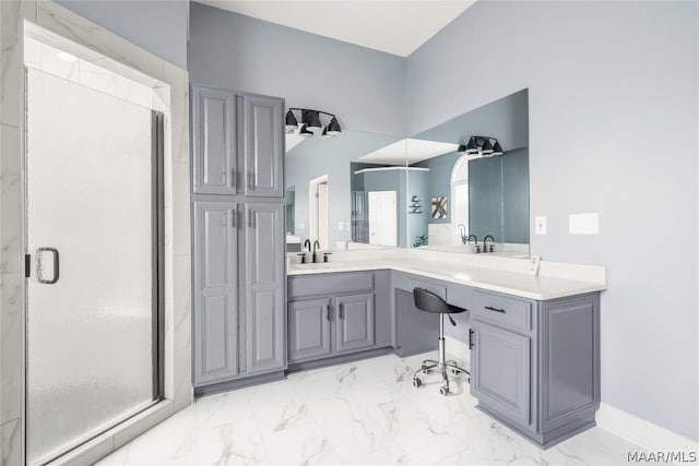 full bath with a stall shower, marble finish floor, a sink, and double vanity