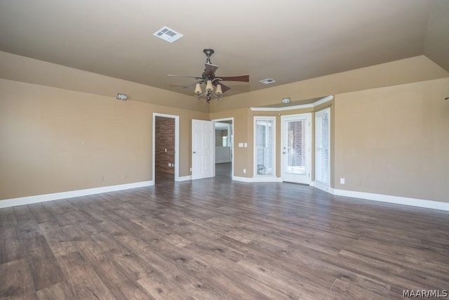 unfurnished room featuring a ceiling fan, visible vents, baseboards, and wood finished floors