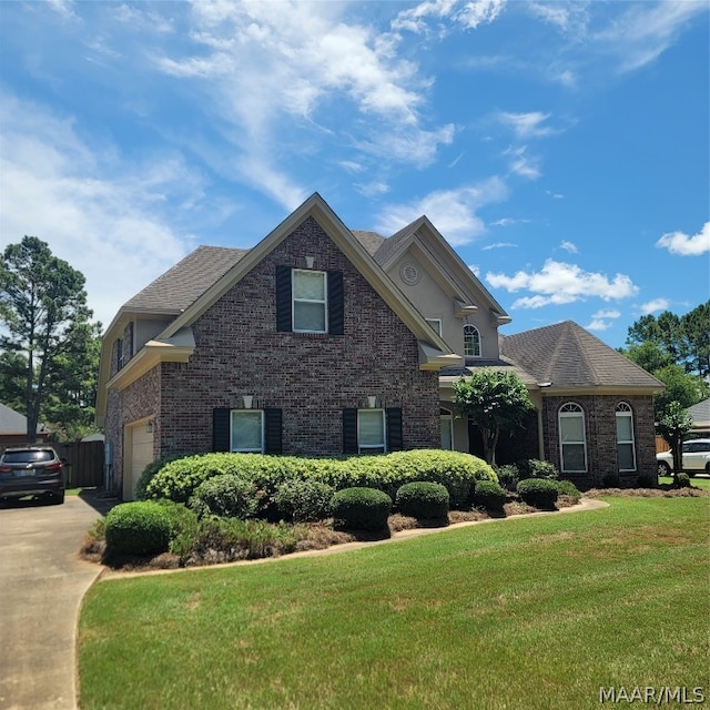 view of front property with a garage and a front yard