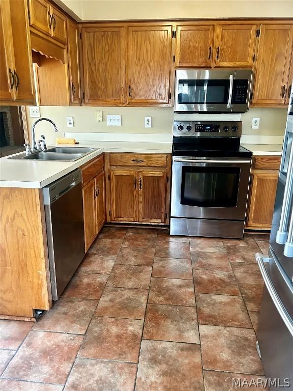 kitchen with sink and appliances with stainless steel finishes