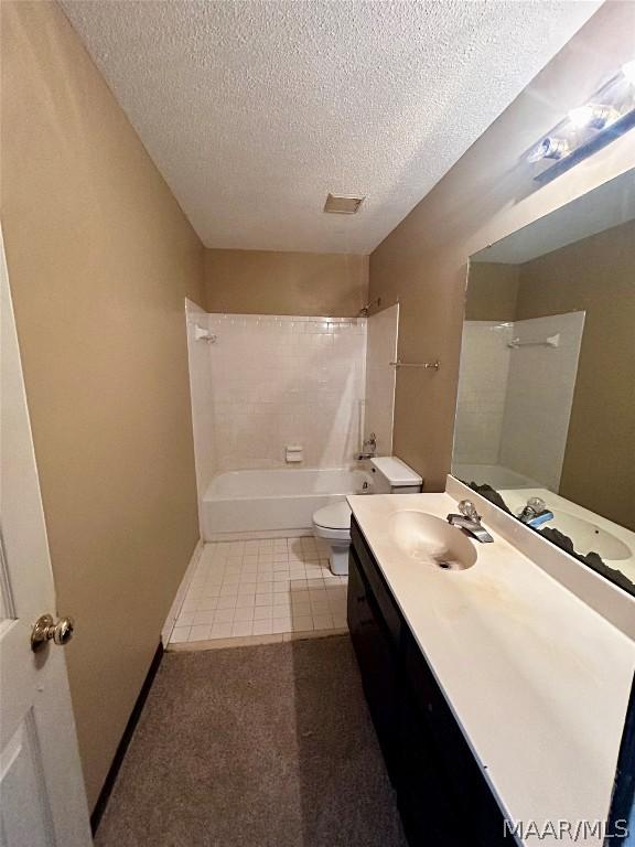 full bathroom with vanity, toilet, shower / bath combination, and a textured ceiling