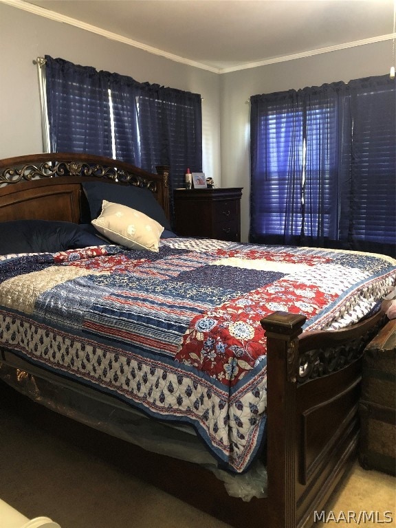 bedroom with carpet floors and ornamental molding