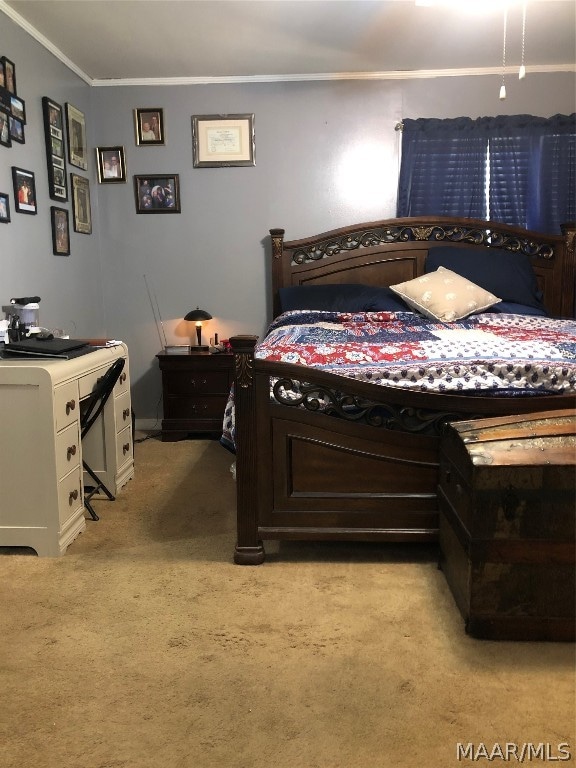 bedroom featuring crown molding and light colored carpet